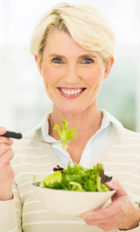 senior female vegetarian eating salad
